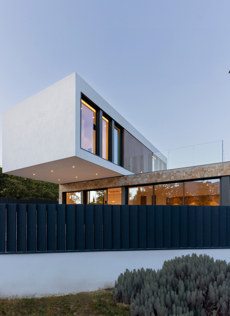 Façade d'une maison préfabriquée à Barcelone avec porte-à-faux et éclairage LED sous le porche